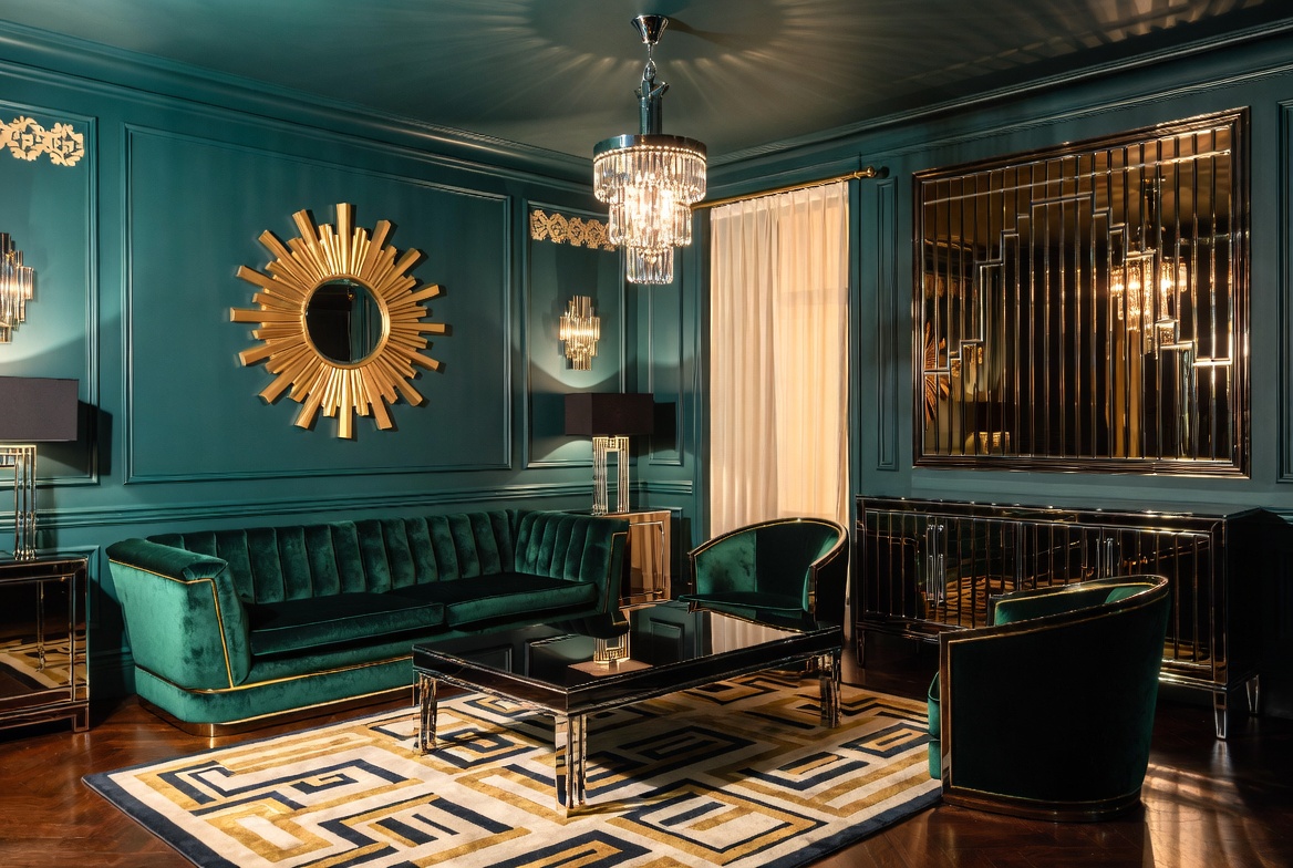 Art Deco living room with emerald velvet sofa, gold sunburst mirror, geometric rug, champagne chandelier, and black lacquered furniture inspired by Jazz Age interior design
