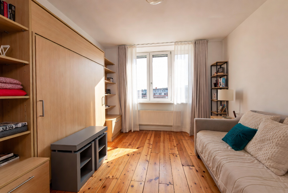 12 tiny space furniture ideas featuring a Murphy bed, storage ottoman, and nesting tables that make a small room feel twice as big.